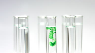 Drop reagent in beakers with liquid