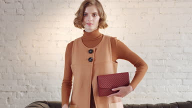 Fashion model posing with leather bag