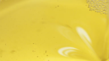 Macro shot of pouring oil