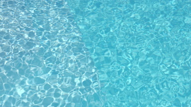 Clean blue transparent water in swimming pool