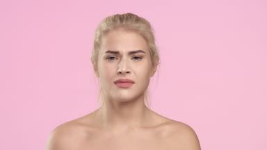 Young woman throws out shaver and smile