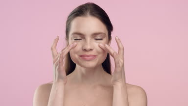 Beauty portrait of young brunette woman touch her skin