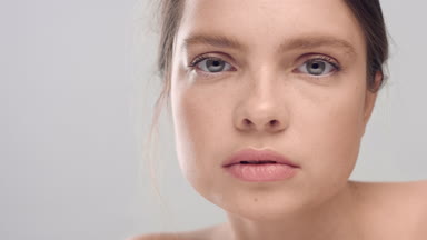 Young Caucasian woman turns and look at the camera