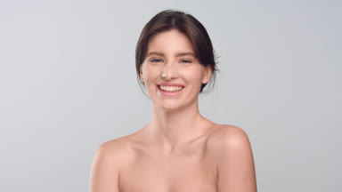 Young attractive healthy woman looking at camera and laughing