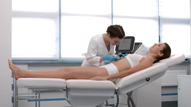 Dermatologist examines patient's skin using dermatoscope