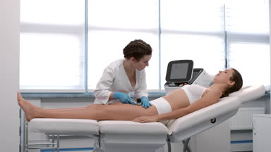 Dermatologist exams patient's skin using dermatoscope