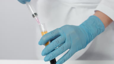 Process of picking up blood plasma from test tube in the syringe