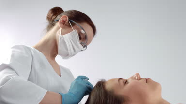 Cosmetologist performs prp plasma injections for hair regrowth