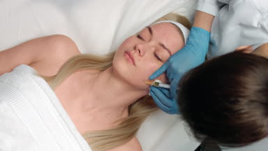Doctor performs platelet rich plasma face injections