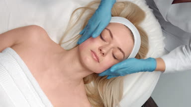 Top view shot of cosmetology facial massage procedure