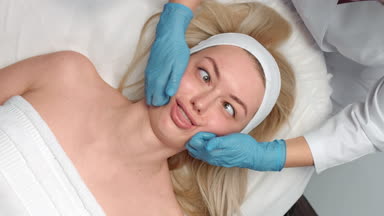 Funny blonde girl have a beauty massage session