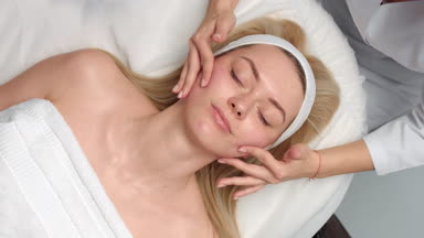 Time lapse of cosmetology facial massage procedure bare hands