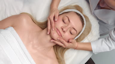 Top view of Cosmetology facial massage procedure bare hands