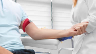 Nurse drawing blood for platelet-rich plasma treatment.