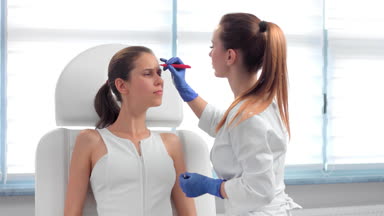 Marking up face before the cosmetology treatment #J8IC149n