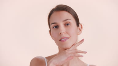 Brown-haired beauty model poses for skin care product commercial