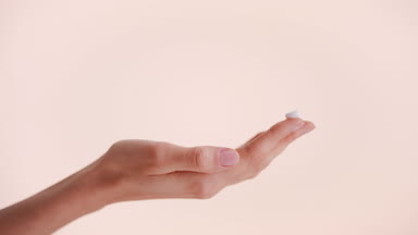 Drop of skin care cream on the tip of the female hand's finger
