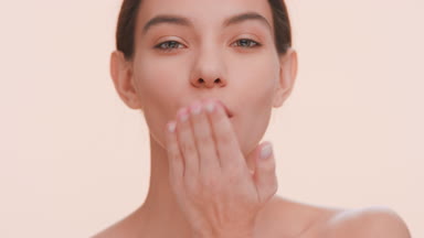 Beauty model blowing a kiss to the camera and smile.