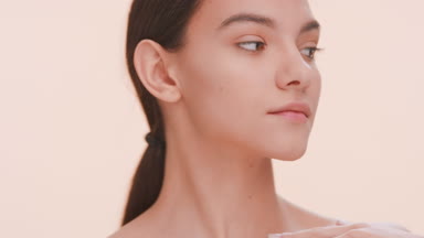 Young woman gently strokes her clavicles.