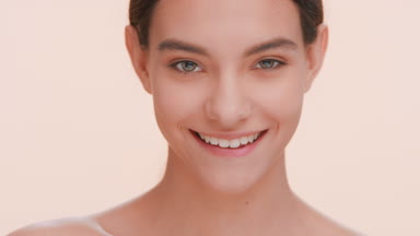 Young positive beauty model looks at the camera and winks