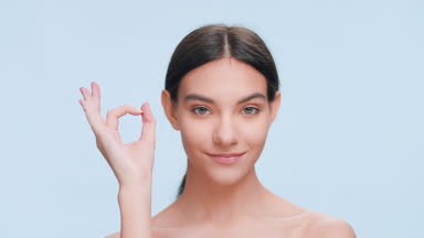 Young woman made an ok hand gesture