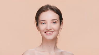 Brunette woman looks up at the camera and smiles