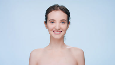 Young woman standing in front of the camera and smiles