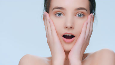 Shocked and surprised young brunette woman