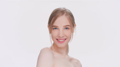 Young light-haired beauty model posing in front of the camera