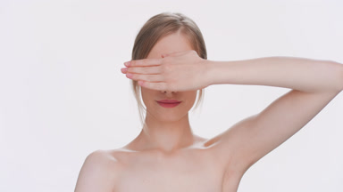 Young blonde woman cover up her eyes with palm and then opens it