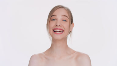 Young attractive blonde woman laughing at the camera