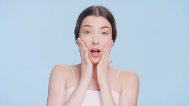 Shocked and surprised young brunette beauty model