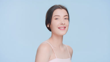 Positive joyful woman turns and looks at camera and smiles