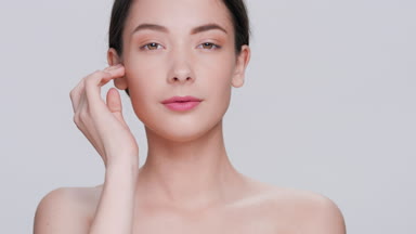 Young brunette woman posing for skin care products commercial