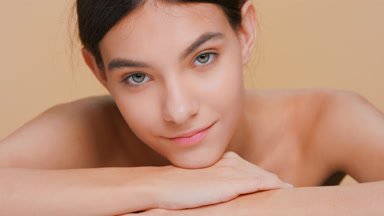Beauty model puts her chin on her forearms and raise it back