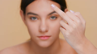 Young attractive woman shows middle finger gesture at camera