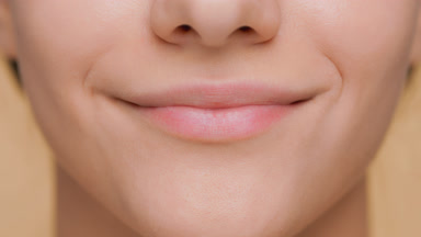 Detail shot of female lips smiling in front of camera