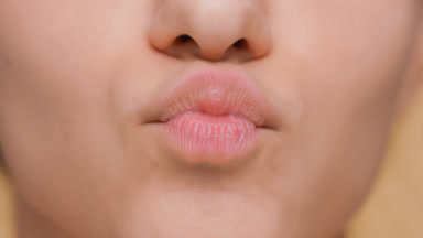 Detail shot of female lips giving a kiss
