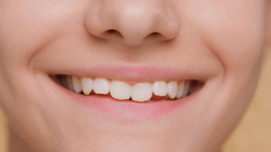 Detail shot of smiling woman | wide smile with teeth