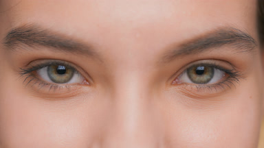 Extreme close-up of young woman opens her eyes