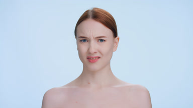 Young ginger woman made disgusting expression on blue background
