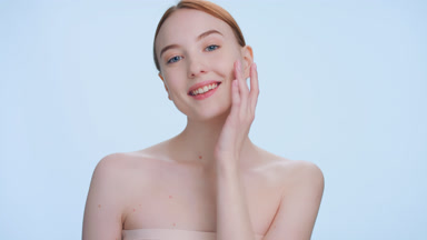 Ginger woman turns and make a step at camera touching her face