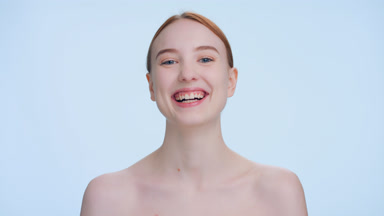 Young attractive ginger woman laughing at the camera