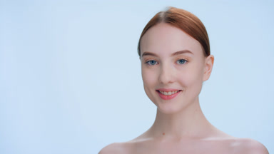 Ginger woman turns to the camera and smiles | place for sign
