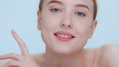 Woman raises her head from incline position and looks at camera