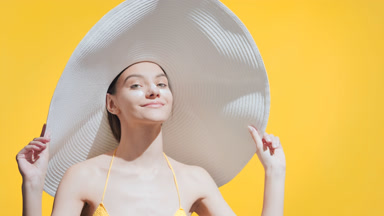 Woman with sunblock on her cheeks and nose turns around smiling