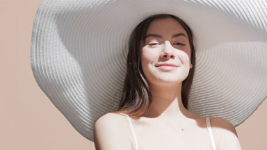 Woman turns around touching her body, enjoying the sun, smiling