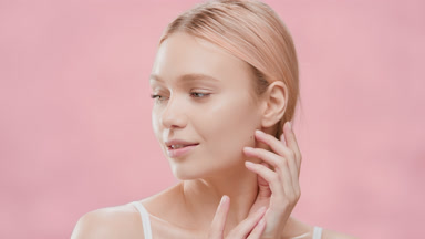 Blond woman opens eyes moving head up and touching her face