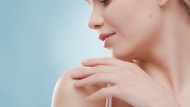 Woman turns her head from side to side touching her clavicles