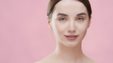 Cute woman moves her head from side to side looking at camera
